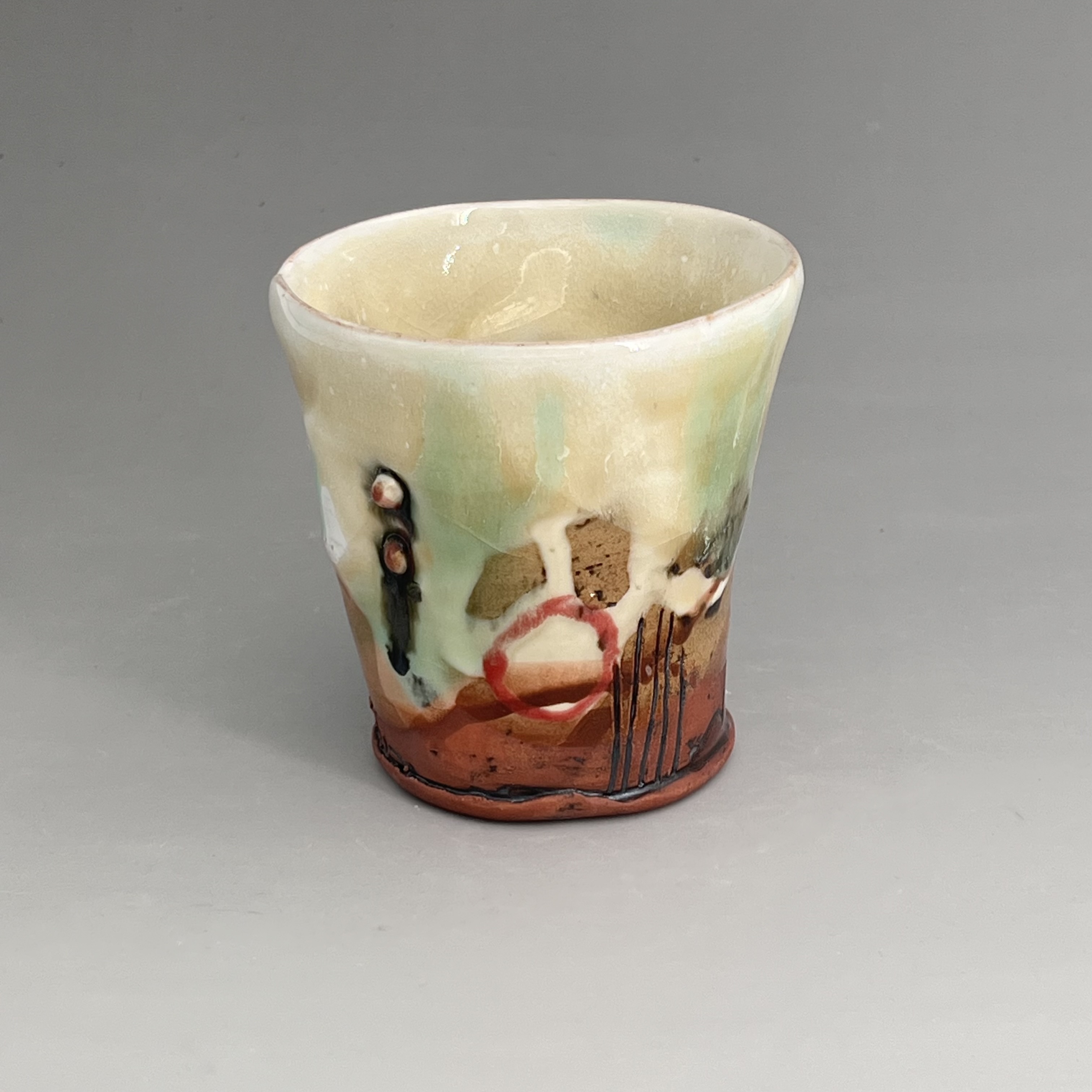 Hand-thrown Splashed glazed pottery cup by Brendan Adams.